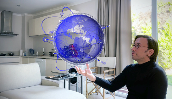 Virtual Ai Designer showing next-generation 3D hologram technology held in his hand. Augmented virtual reality is about to become a part of life in the near future. / You can see the animation movie of this image from my iStock video portfolio. Video number: 2098342067