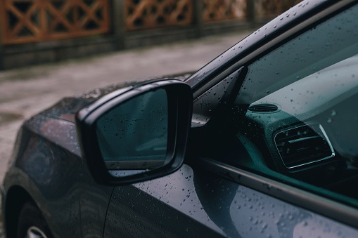 Side rearview mirror of the car in a rain drops