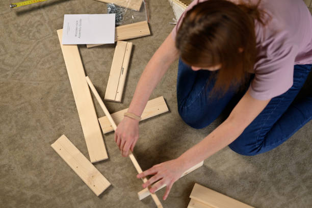 istock view of woman assembling shelving process at home according to instructions 2115251334