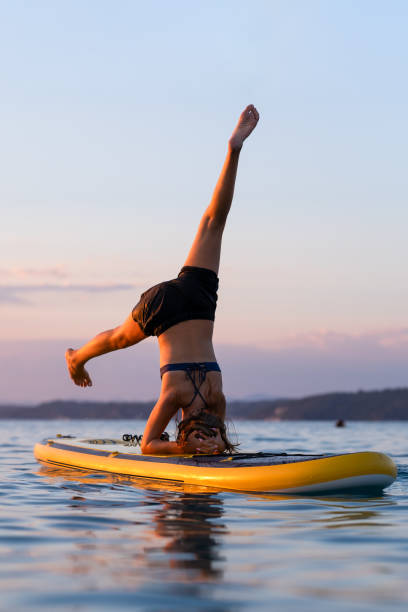 istock SUP yoga on a puddle board at beautiful sunset 2115261136