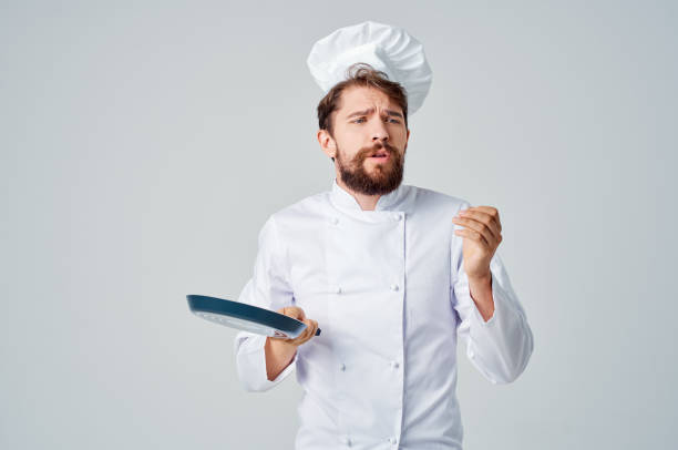 istock bearded man chef with a frying pan in hand culinary industry 2115285787