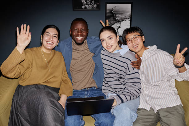 istock Multiethnic business team waving at camera 2115291545