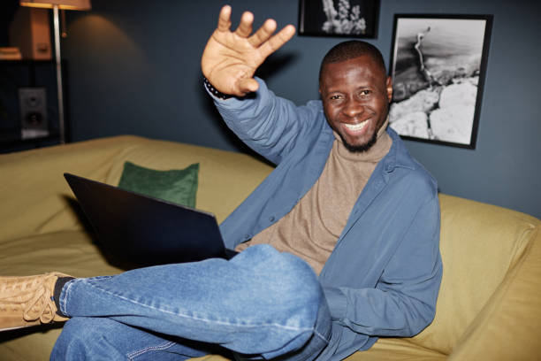 istock Businessman smiling at camera sitting on couch 2115291552