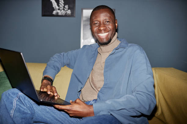 Cheerful adult Black man in office with flash