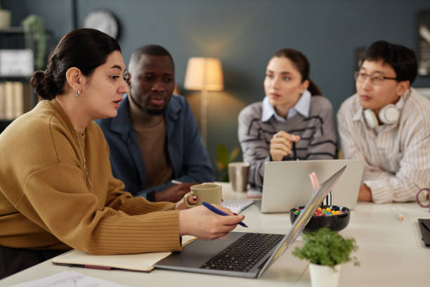 istock Middle Eastern Woman Presenting Ideas at Meeting 2115292103