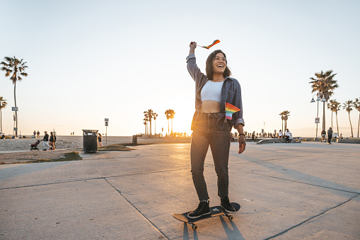 Young woman skating at sunset in Venice Beach, California.