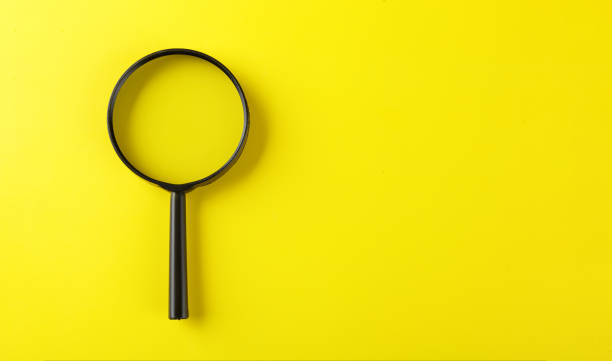 istock Magnifying glass on a yellow background 2115315016