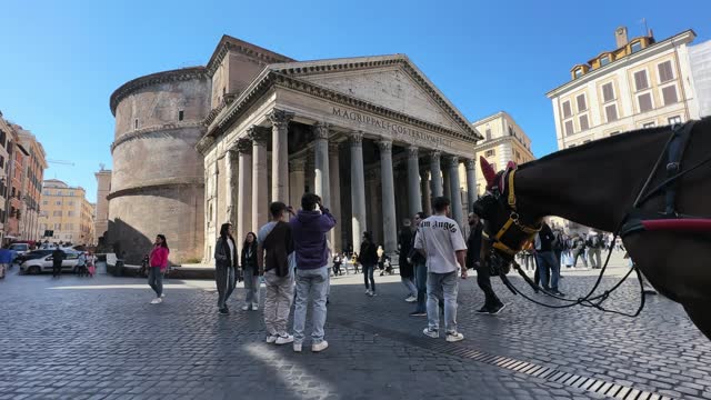 Horse carriage for tourists parked at Piazzza della Rotonda with Pantheon, an ancient Roman architecture masterpiece, it was the temple of all the gods. Rome Pantheon is one of the best known landmarks of Rome and Italy.