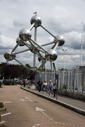 Brussels, Belgium - May 19 2019: People walk and take photos at the base of the Atomium building in Brussels.
