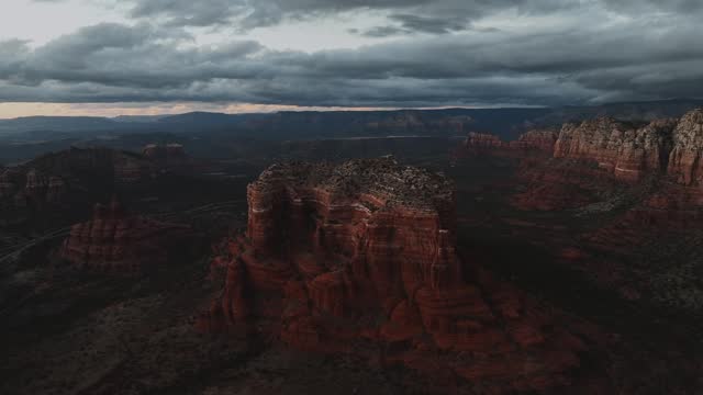 Cloudy Sunset Sky Over Cour house Butte and Bell Rock in Sedona Arizona, USA. aerial ascending shot