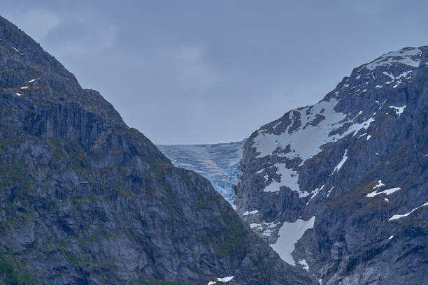 istock Bondhusbreen Glacier hanging over the Bondhusvatnet Lake. 2115363946