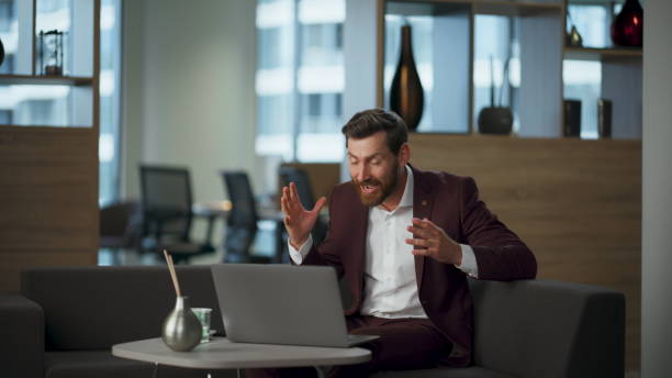istock Excited manager gesturing hands looking laptop at office interior. Man rejoicing 2115369733