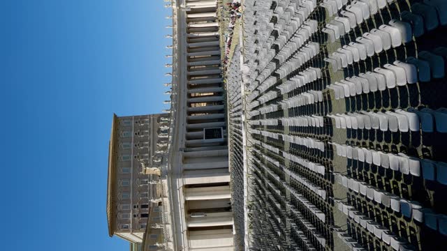 Aerial view of rows of empty chairs on Saint Peter square in Vatican prepared for Eastern holiday mass ceremony, vertican orientation