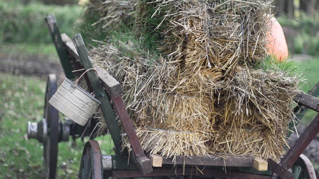 Old vintage cart with dry yellow straw bale