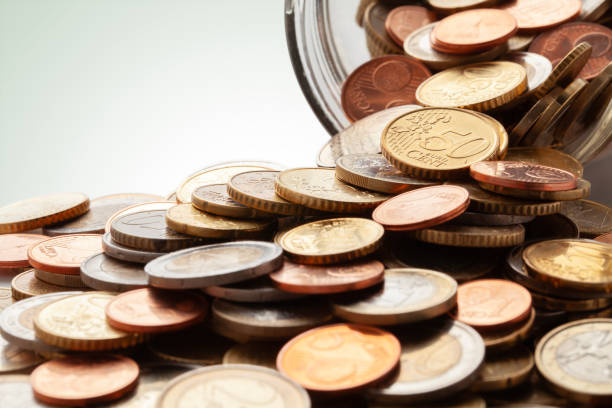 istock Euro coins in a glass jar 2115375386