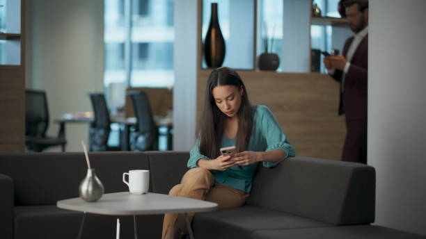 istock Focused entrepreneur reading cellphone email at open space. Woman typing phone 2115389662