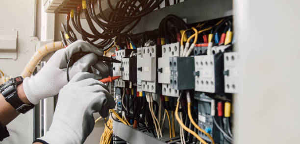 istock Electrician engineer tests electrical installations and wires on relay protection system. 2115404368