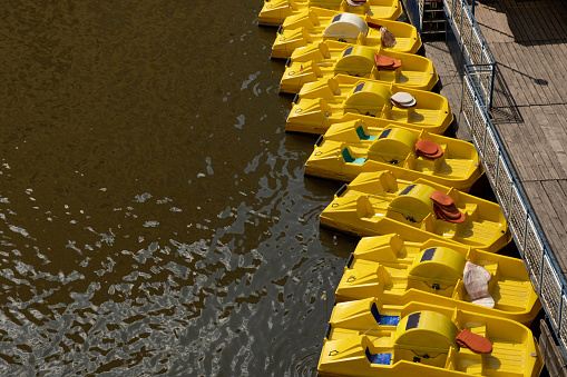 Empty yellow pedal boat on the river for tourists' entertainment in Prague during the summer tourist season.