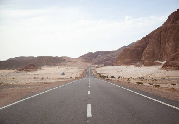 istock Long asphalt road in the desert. 2115441638