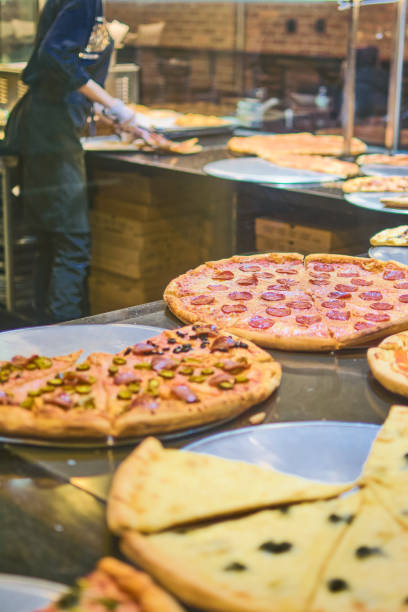 istock Variety of fresh pizzas on display. 2115446237
