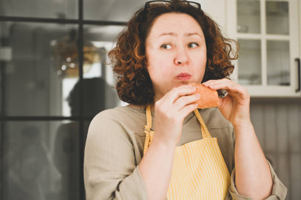 istock Woman eating fresh bread 2115461224