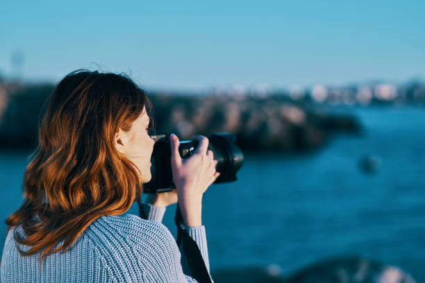 istock woman outdoors and professional camera rocky mountains landscape fresh air 2115473985