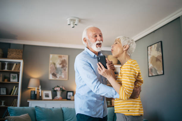 istock Senior heterosexual couple dancing at home. 2115492018