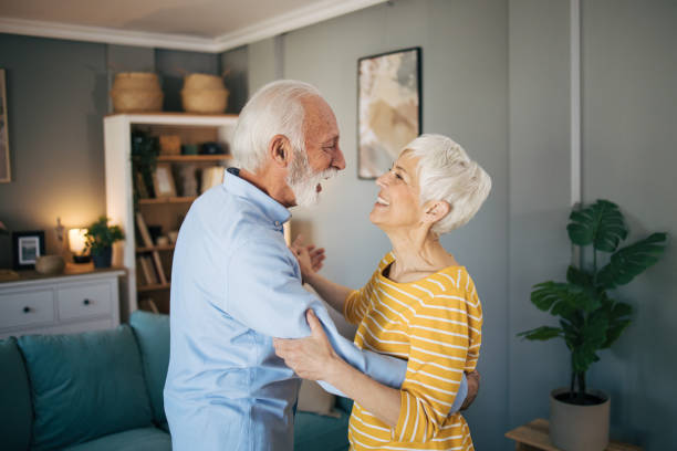 istock Senior heterosexual couple dancing at home. 2115495171