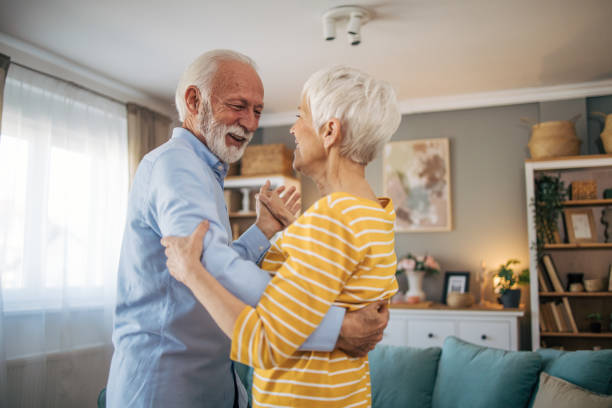 istock Senior heterosexual couple dancing at home. 2115501570