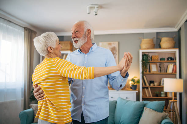 istock Senior heterosexual couple dancing at home. 2115502210