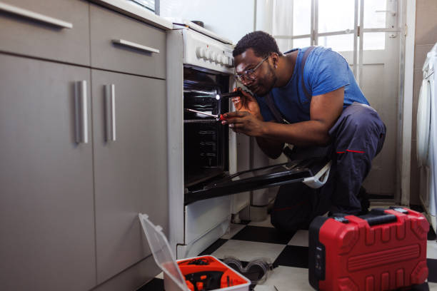 istock Young handyman working repairing stove 2115503268