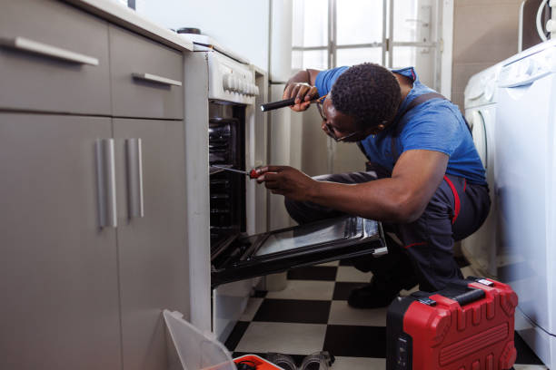 istock Young handyman working repairing stove 2115503272