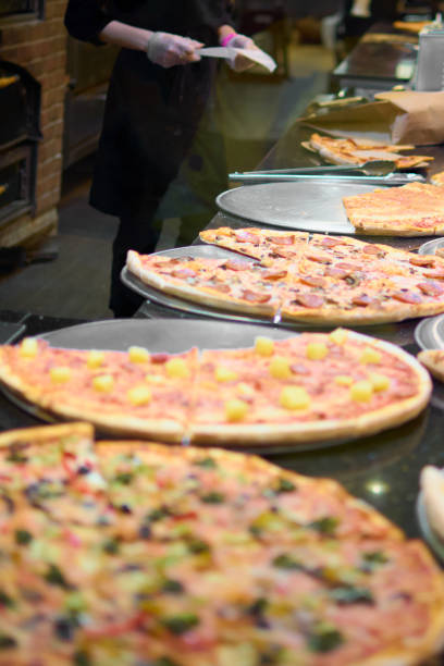 istock Variety of fresh pizzas ready to serve in a restaurant kitchen 2115509045
