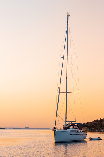 Yacht in harbour at sunset, in summer