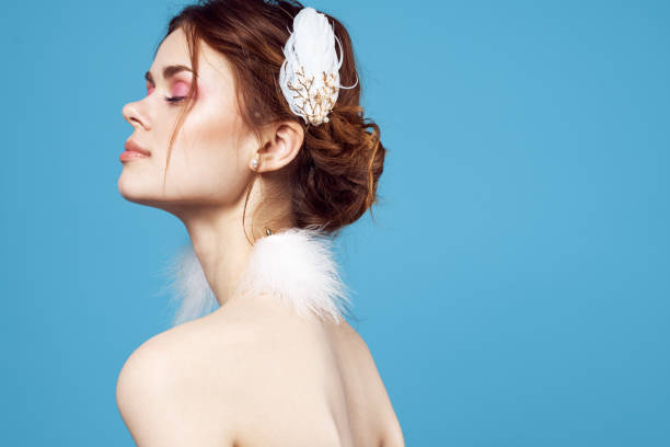 beautiful woman   shoulders fluffy earrings bright makeup freshness. High quality photo