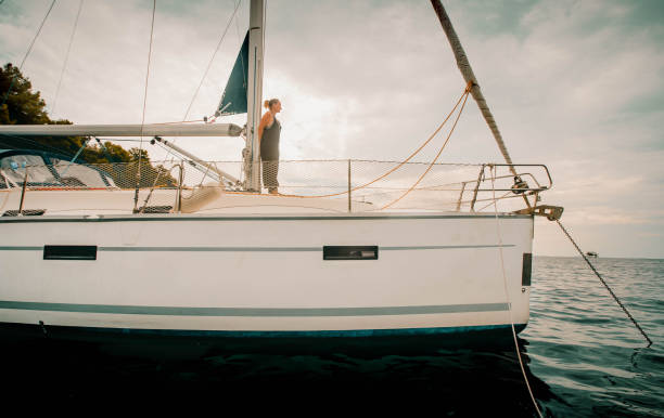 istock Young woman relaxes on sailboat 2115532205