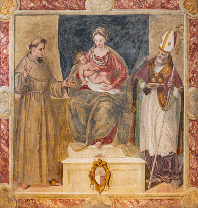 Treviso - The fresco of Madonna with the St. Francis of Assisi and st. Nicholas in the church Chiesa di San Francesco (1570).