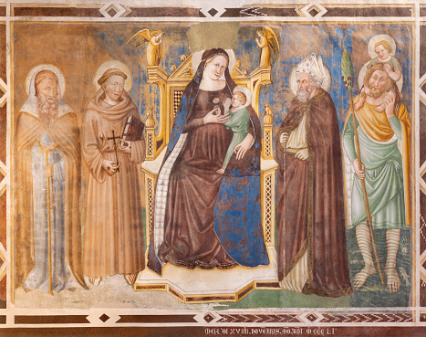 Treviso - The fresco of Madonna with saints Anthony abbot, Francis, Bonaventure and Cristopher in the church Chiesa di San Francesco by Maestro di Feltre (1351).