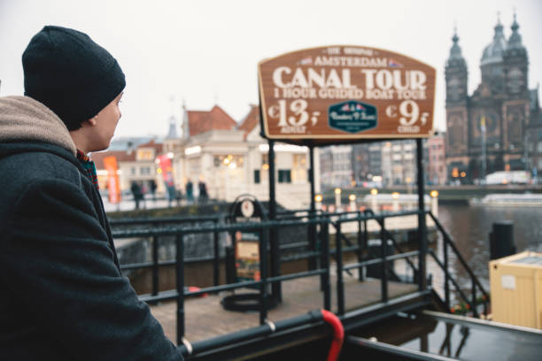 Young Man enjoying Canal tour in Amsterdam