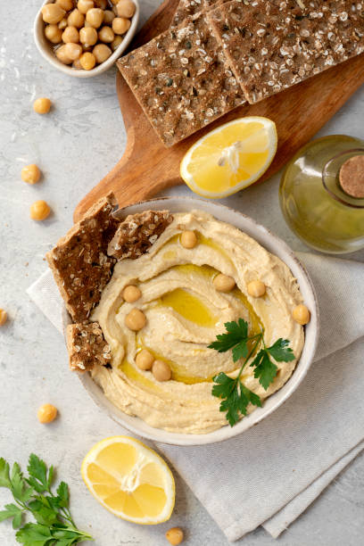 istock Fresh hummus with chickpea olive oil and lemon  with multigrain crackers 2115598212