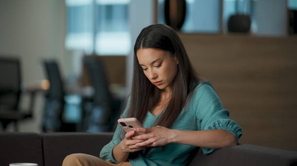 istock Calm woman scrolling feed resting office closeup. Executive watching smartphone 2115608169