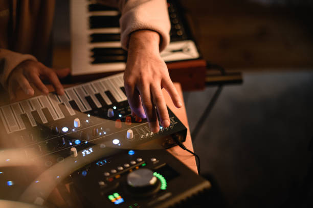 istock Musician records music in a recording studio using professional equipment 2115654865