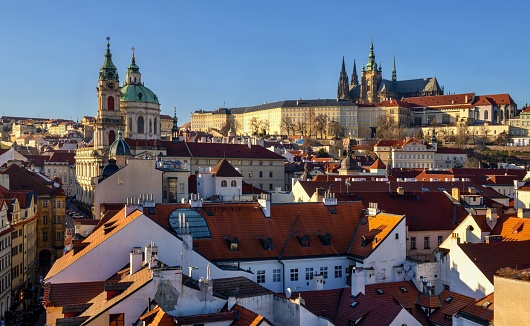 Prague, Czech Republic, January 28, 2024: View of the Prague Castle - seat of the Czech president - and the St. Vitus cathedral. On the left is the church of St. Nicholas