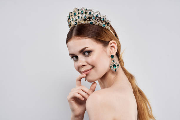 istock Princess with a crown on her head makeup model isolated background 2115663521