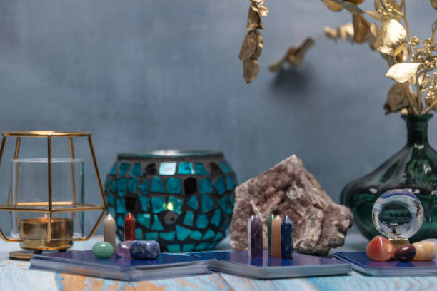 istock A tarot card reading setup with an array of colorful healing crystals on a weathered wooden table, invoking a sense of mysticism. 2115672987