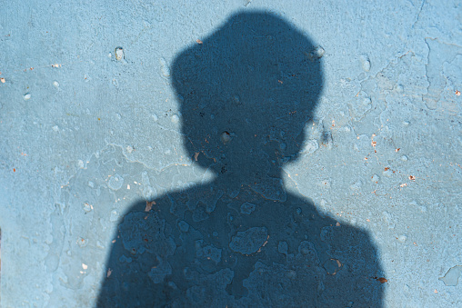 Shadow cast on a wall by an unidentified person. Texture