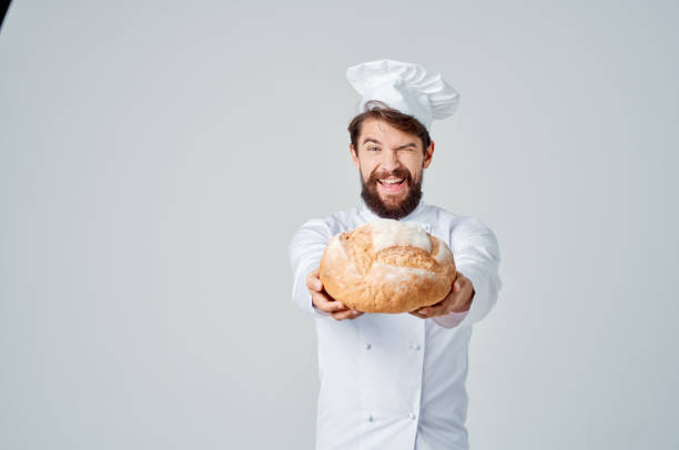 istock bearded man chef with bread in hand isolated background 2115753106