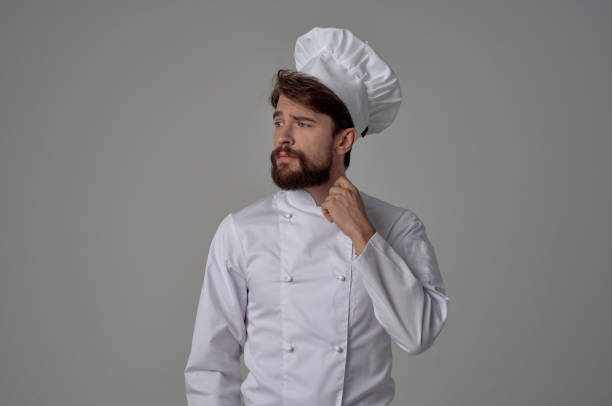 istock bearded man Chef uniform Cooking emotions gourmet light background 2115753175