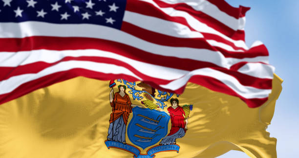 istock New Jersey state flags waving with the american flag on a clear day 2115760329