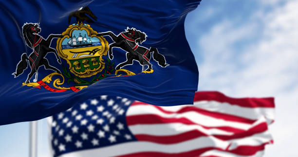 istock Pennsylvania state flag waving with the american flag 2115762878